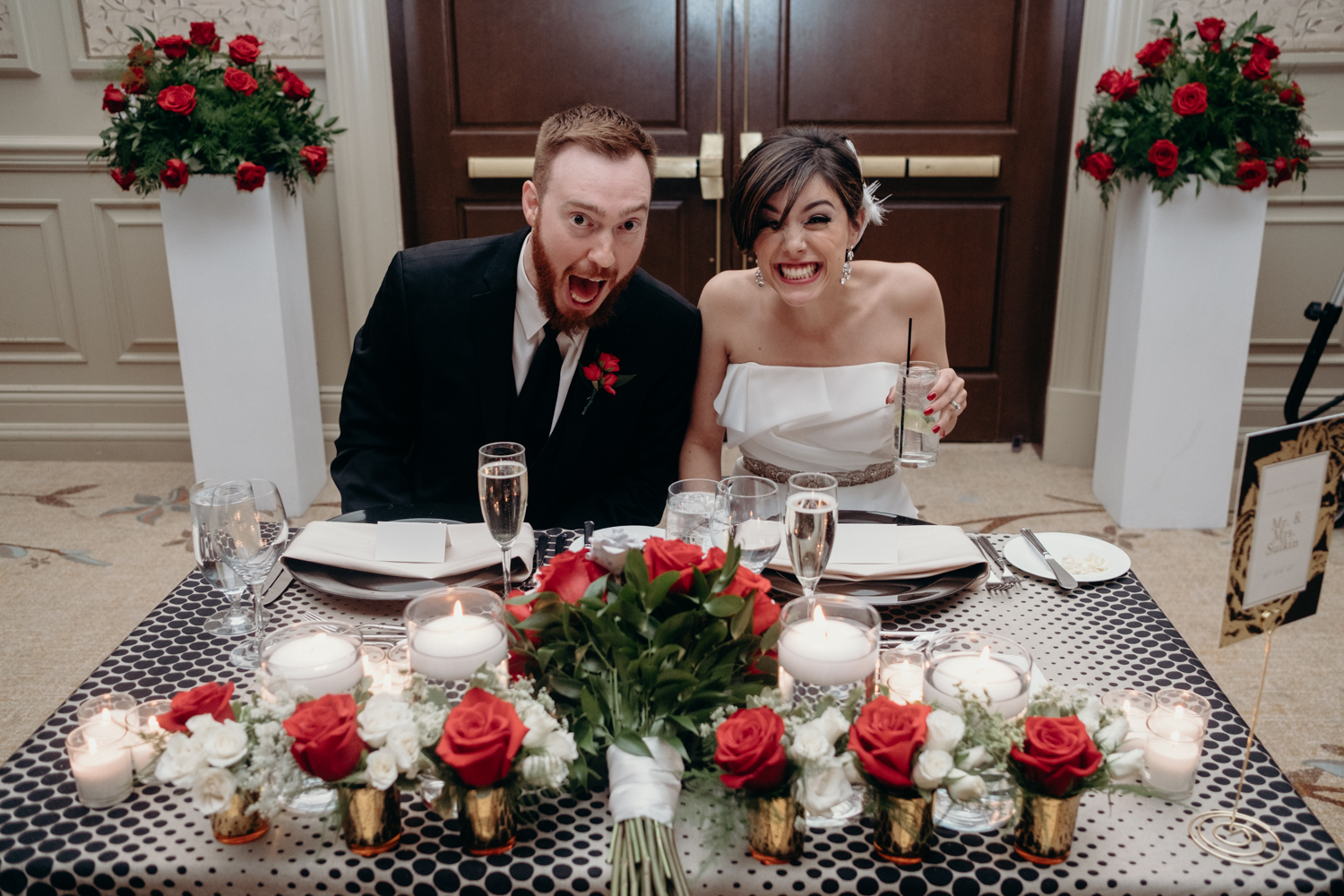 bride and groom at their table excited to eat