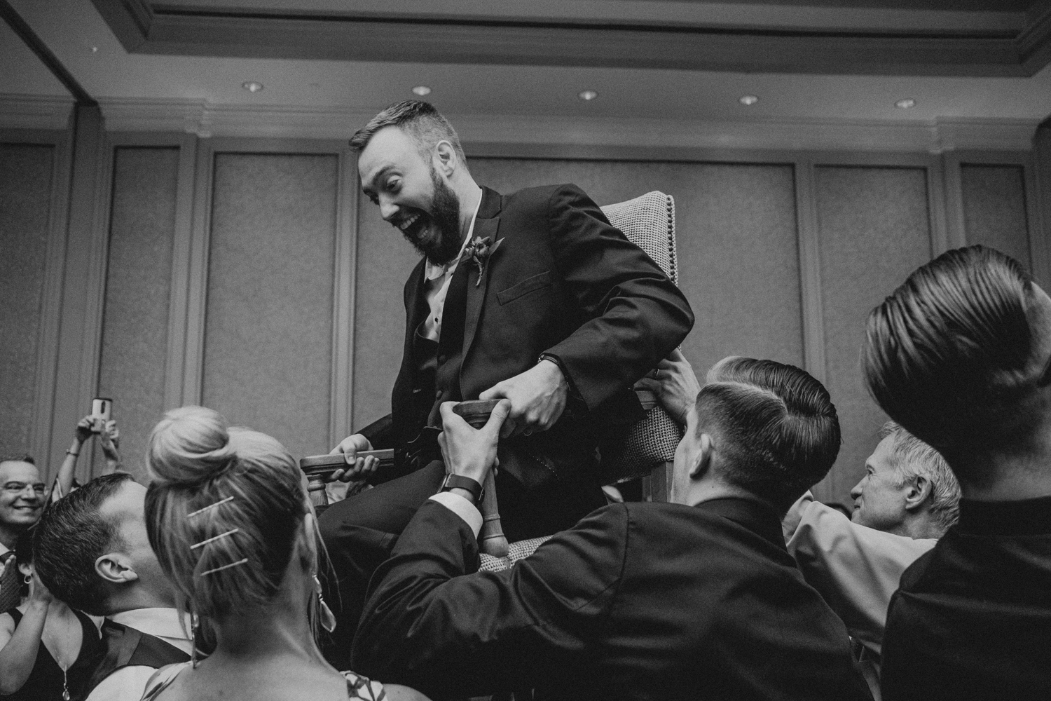 groom is lifted in his chair during the hora at Salamander Resort wedding