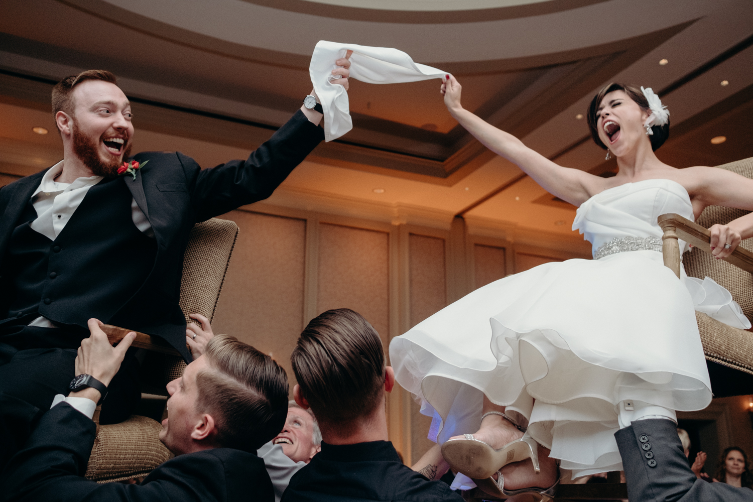 bride and groom in the air during fun hora dance at Virginia Jewish wedding