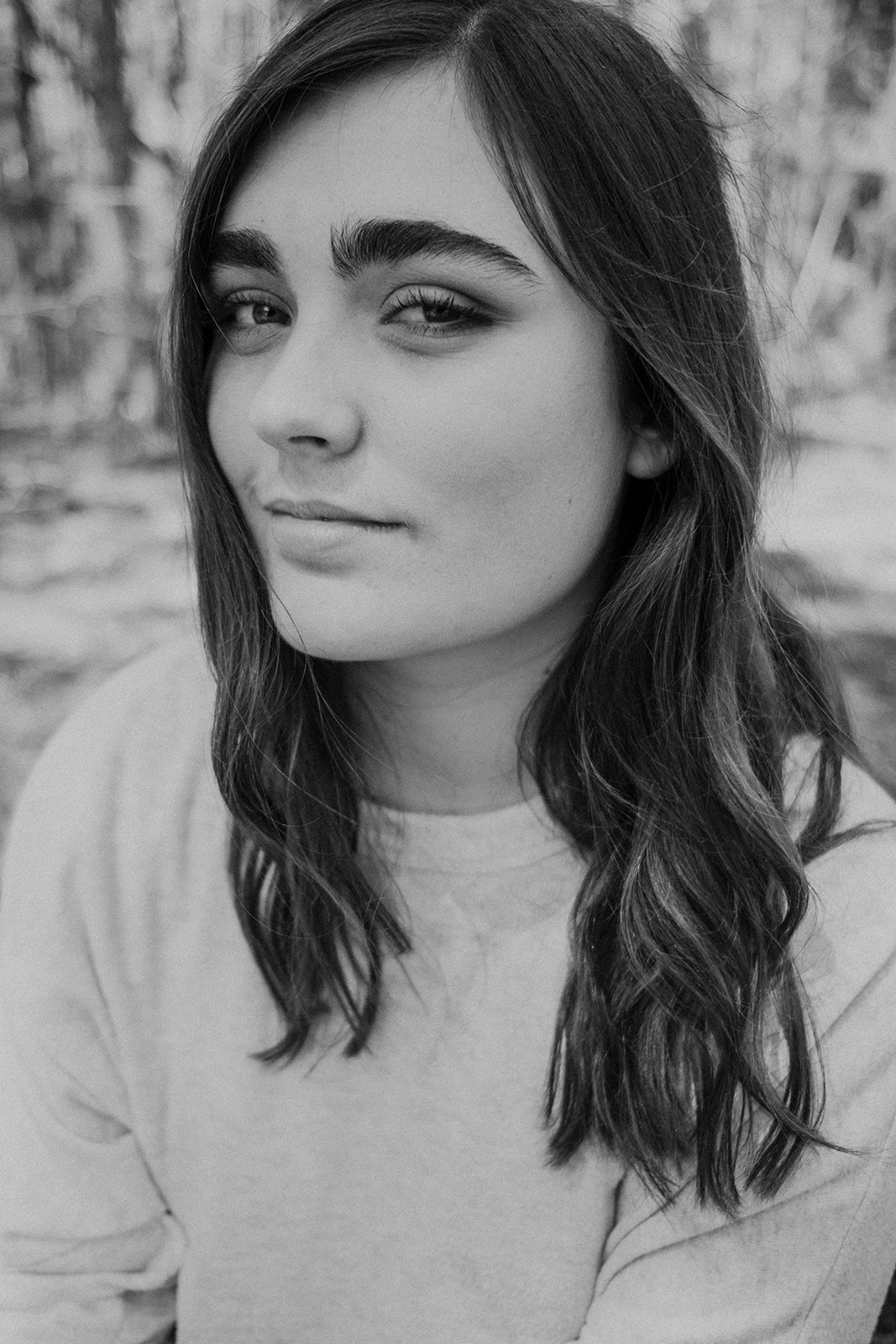 A girl looks into the camera during her senior portrait session in North Carolina. 