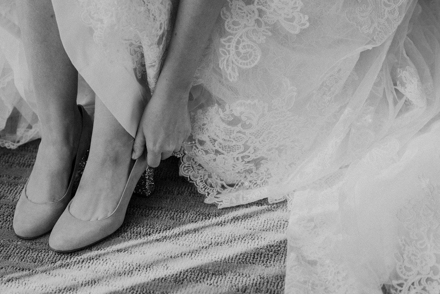 A bride puts on her shoes before her wedding at Lansdowne Resort.