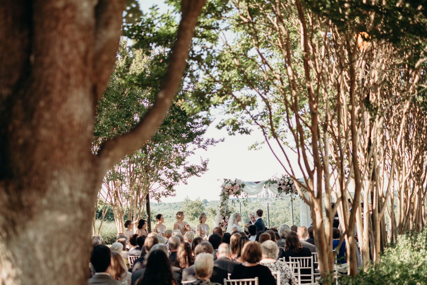 A wedding ceremony is celebrated on the tree-lined patio at Lansdowne Resort. 