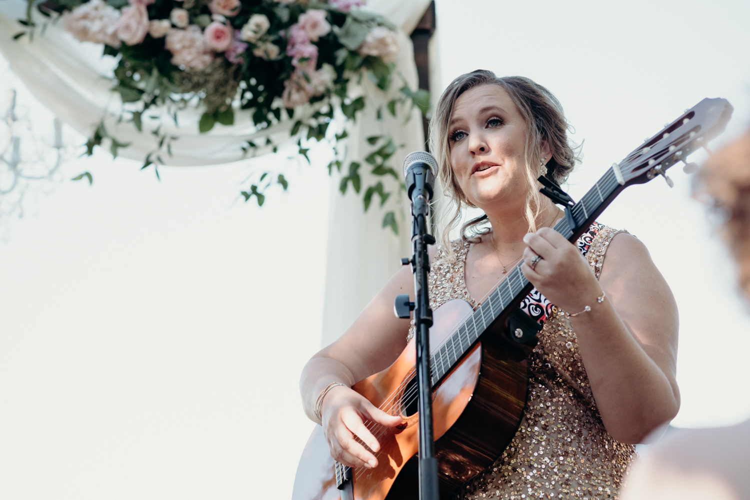 A bridesmaid performs a song during her sisters wedding ceremony at Lansdowne Resort. 