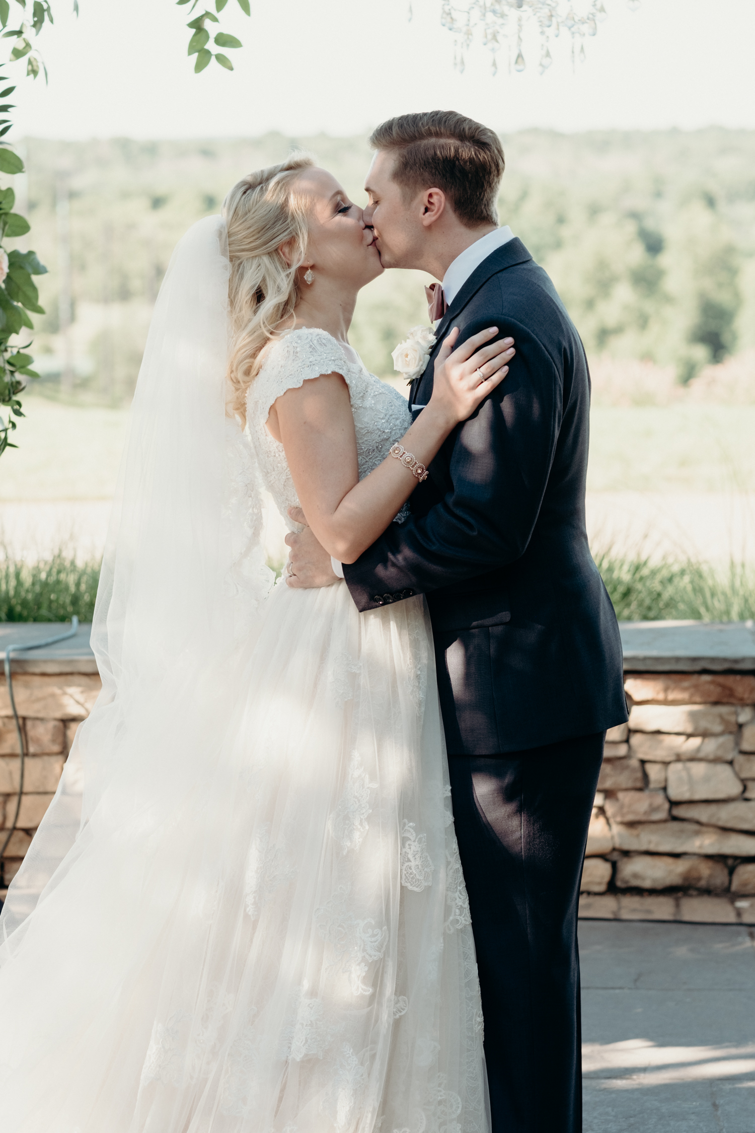 A bride and groom share their first kiss during their outdoor wedding ceremony at Lansdowne Resort.