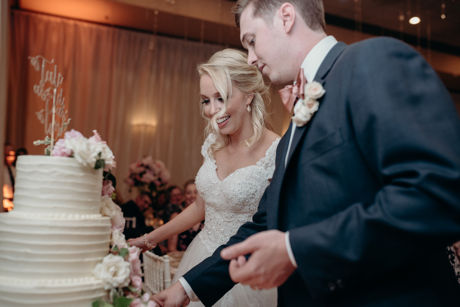 A bride and groom cut the cake at their wedding reception at Lansdowne Resort. 