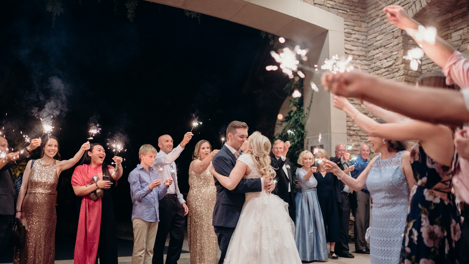 A bride and groom share a kiss during their sparkler exit after their wedding reception at Lansdowne Resort.