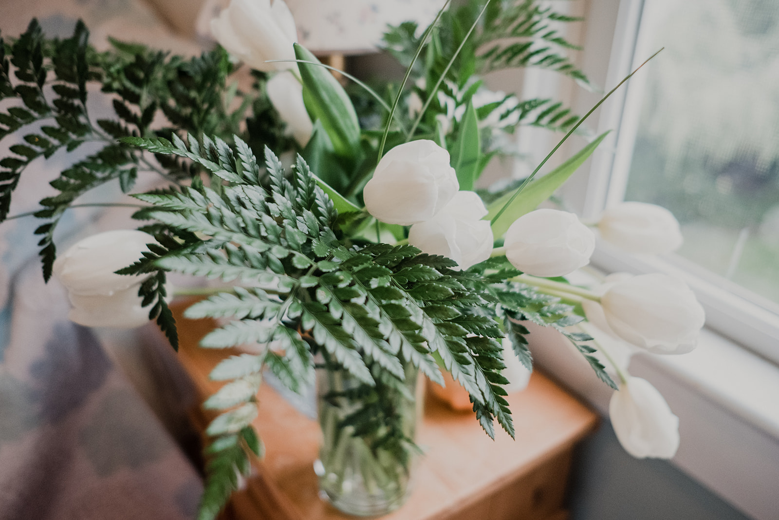 White tulips and ferns adorn the getting ready room at Blue Hill Farm in Waterford, VA. 
