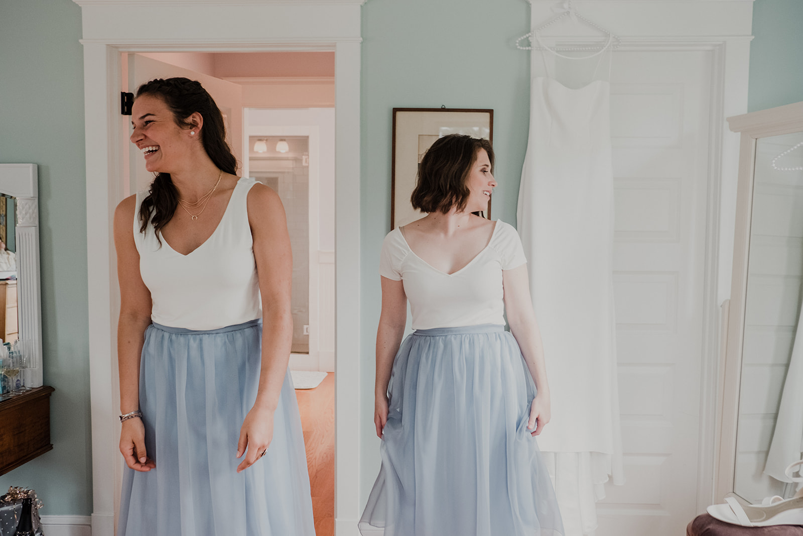 Bridesmaids in cream tops and blue tulle skirts take a moment before the outdoor wedding ceremony at Blue Hill Farm in Waterford, VA. 