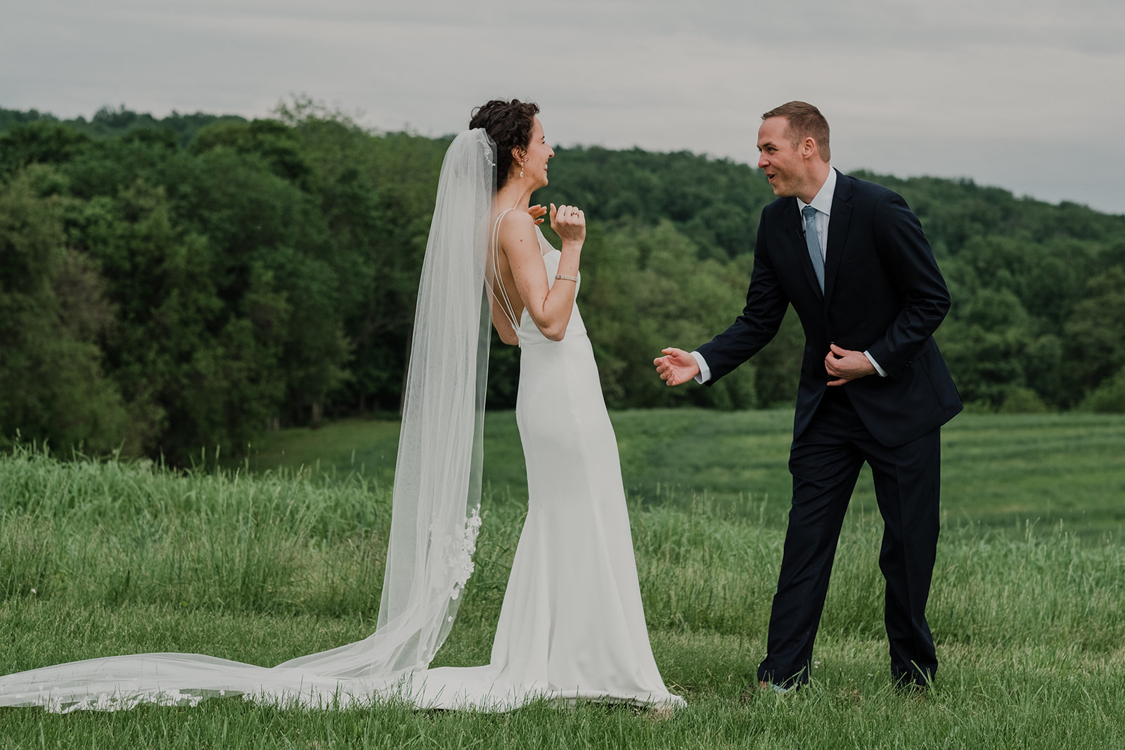 A groom is wowed by how gorgeous his bride is during a first look before their outdoor wedding at Blue Hill Farm in Waterford, VA.