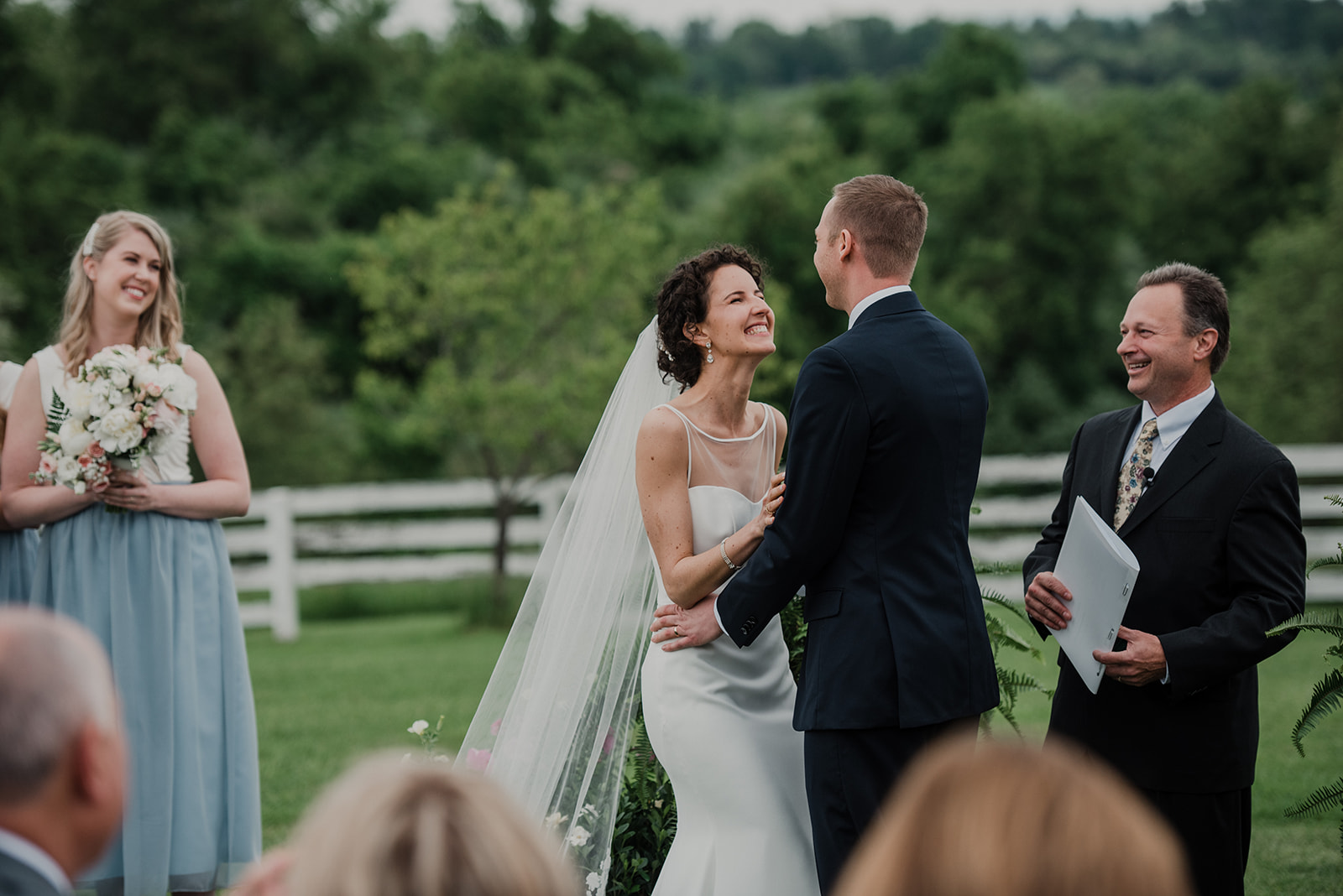 A newly pronounced husband and wife are all smiles during their outdoor wedding ceremony at Blue Hill Farm in Waterford, VA.