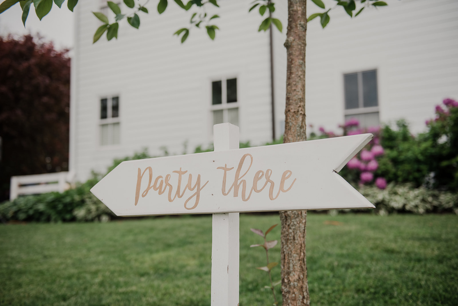 A sign denotes where the party is for a wedding reception at Blue Hill Farm in Waterford, VA.