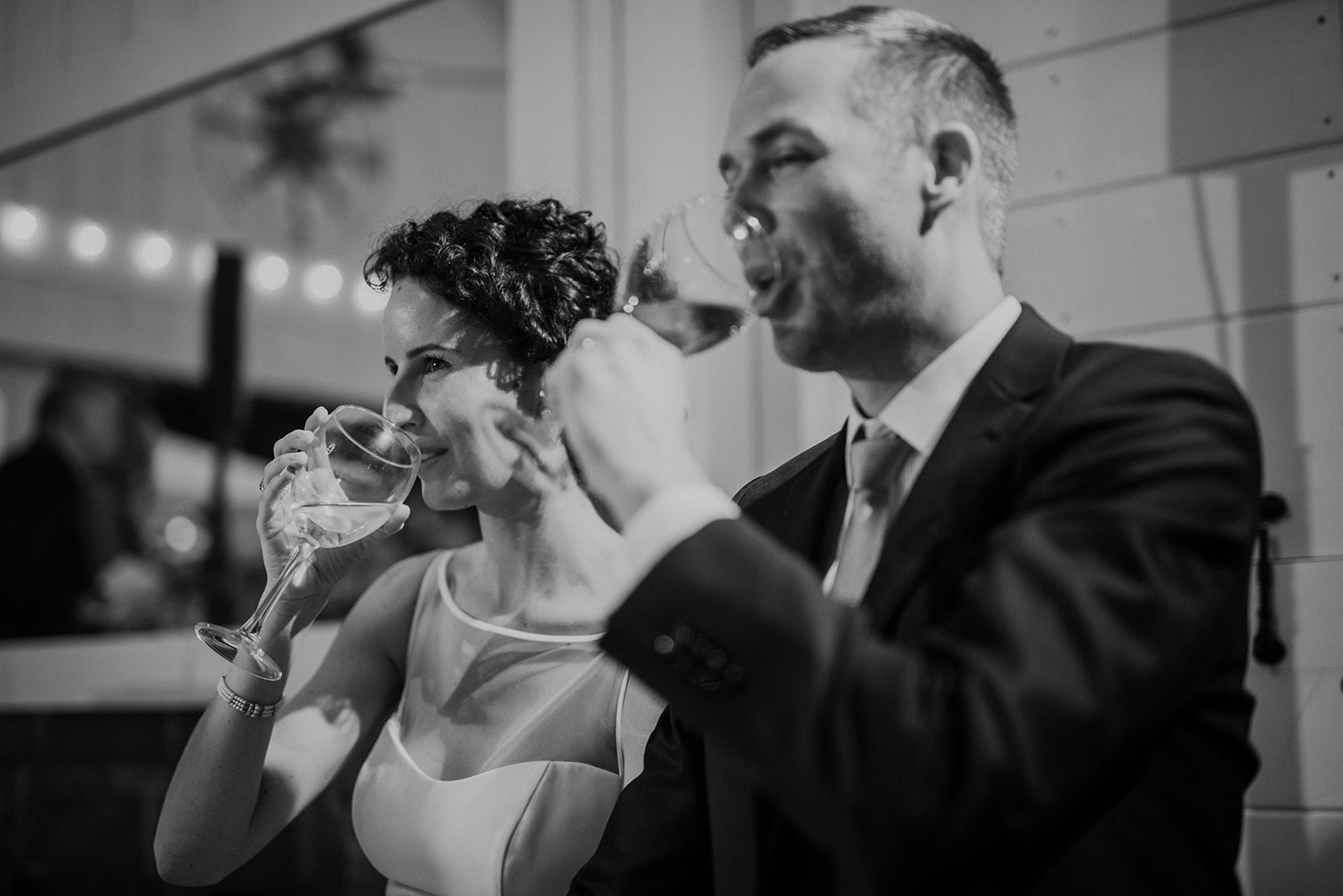 A bride and groom sip champagne after the toasts at their reception at Blue Hill Farm in Waterford, VA.