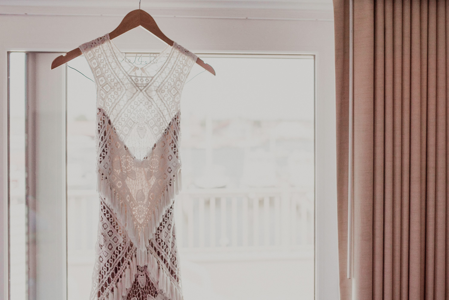 gorgeous rue de seine dress hanging in hotel room before wedding