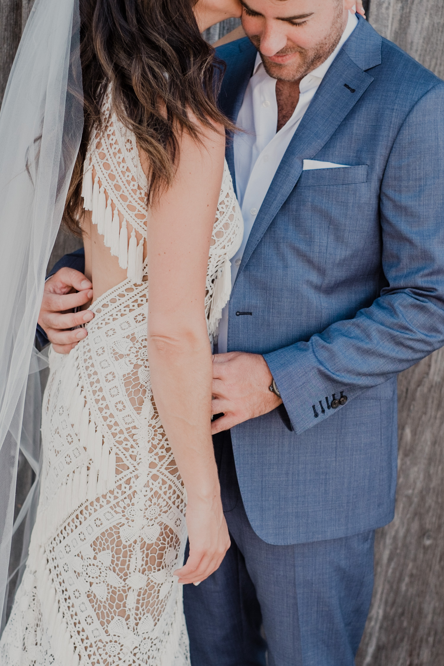 bride and groom hold each other close during first look embrace