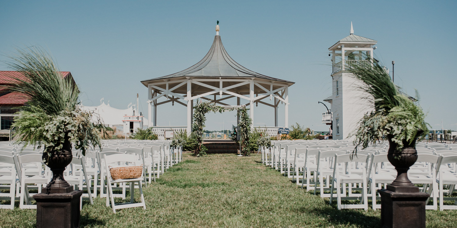 chesapeake bay maritime museum ceremony views with beautiful greenery accents and chuppah 