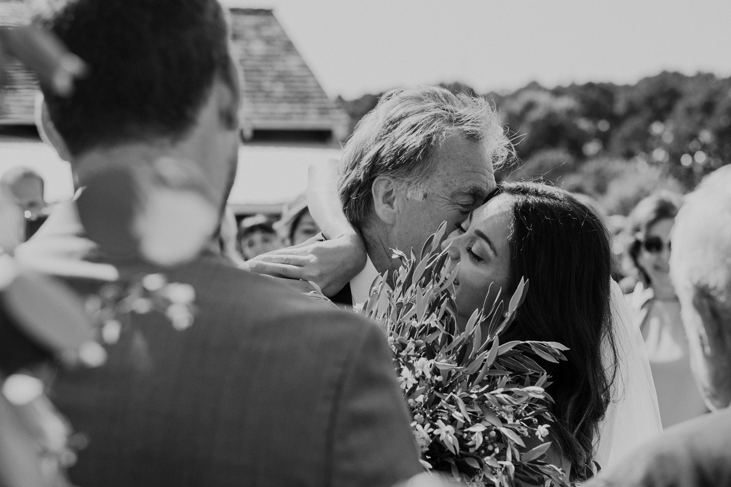 bride embraces father as he gives her away at the end of the aisle during wedding