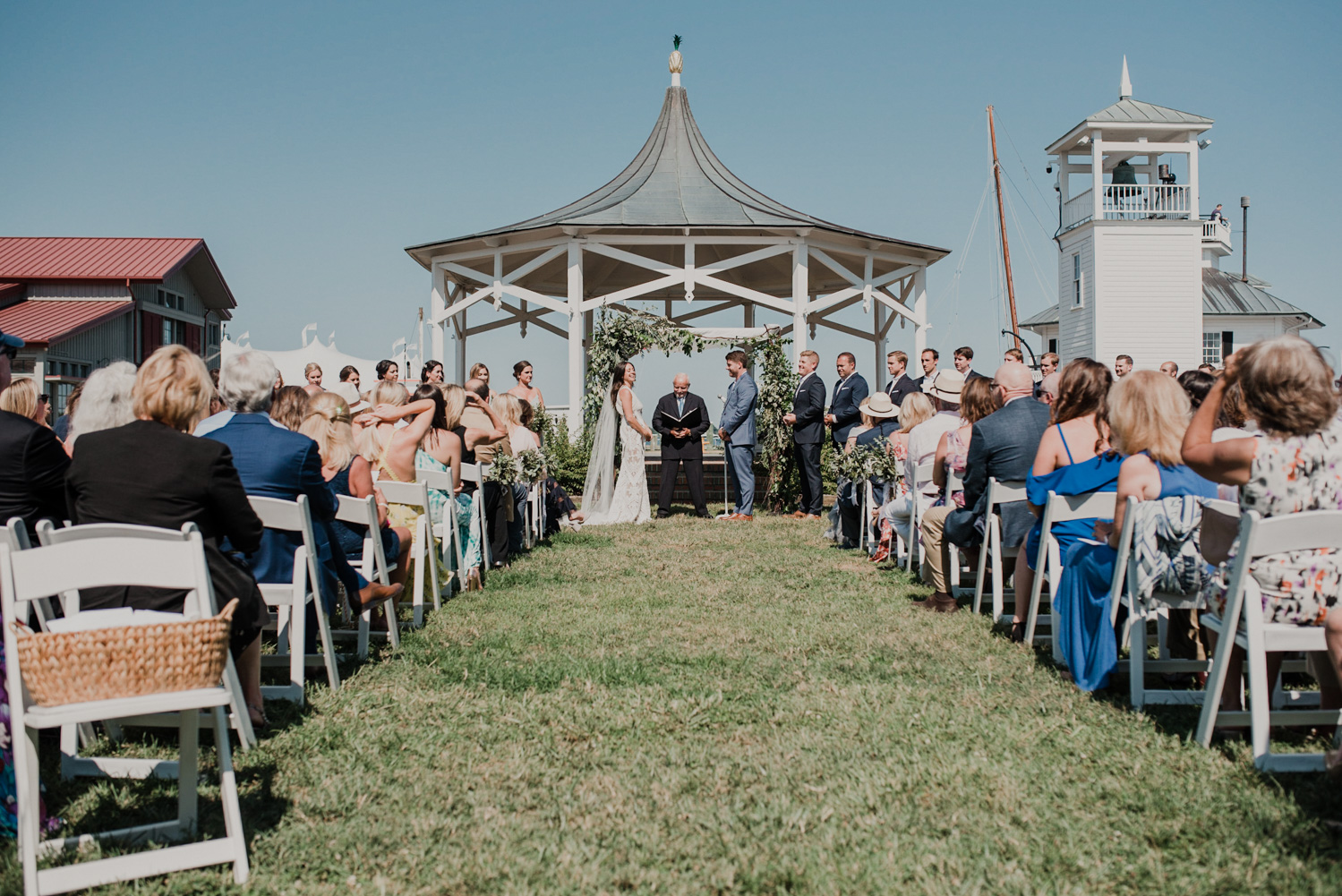 wedding ceremony at chesapeake bay maritime museum on a bright and sunny day