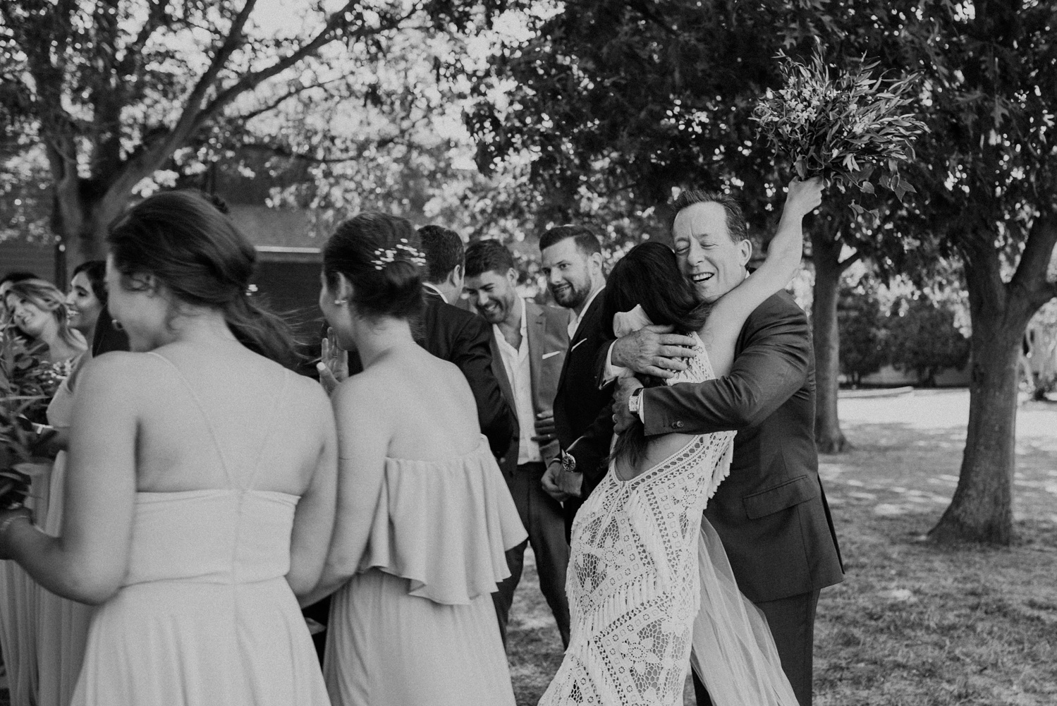 bride embraces her new father-in-law at the end of the wedding ceremony