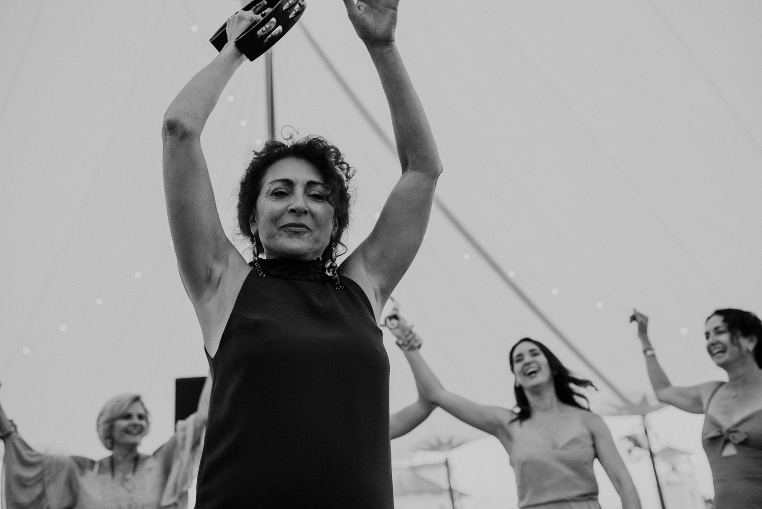 woman dances with tambourine during wedding dance