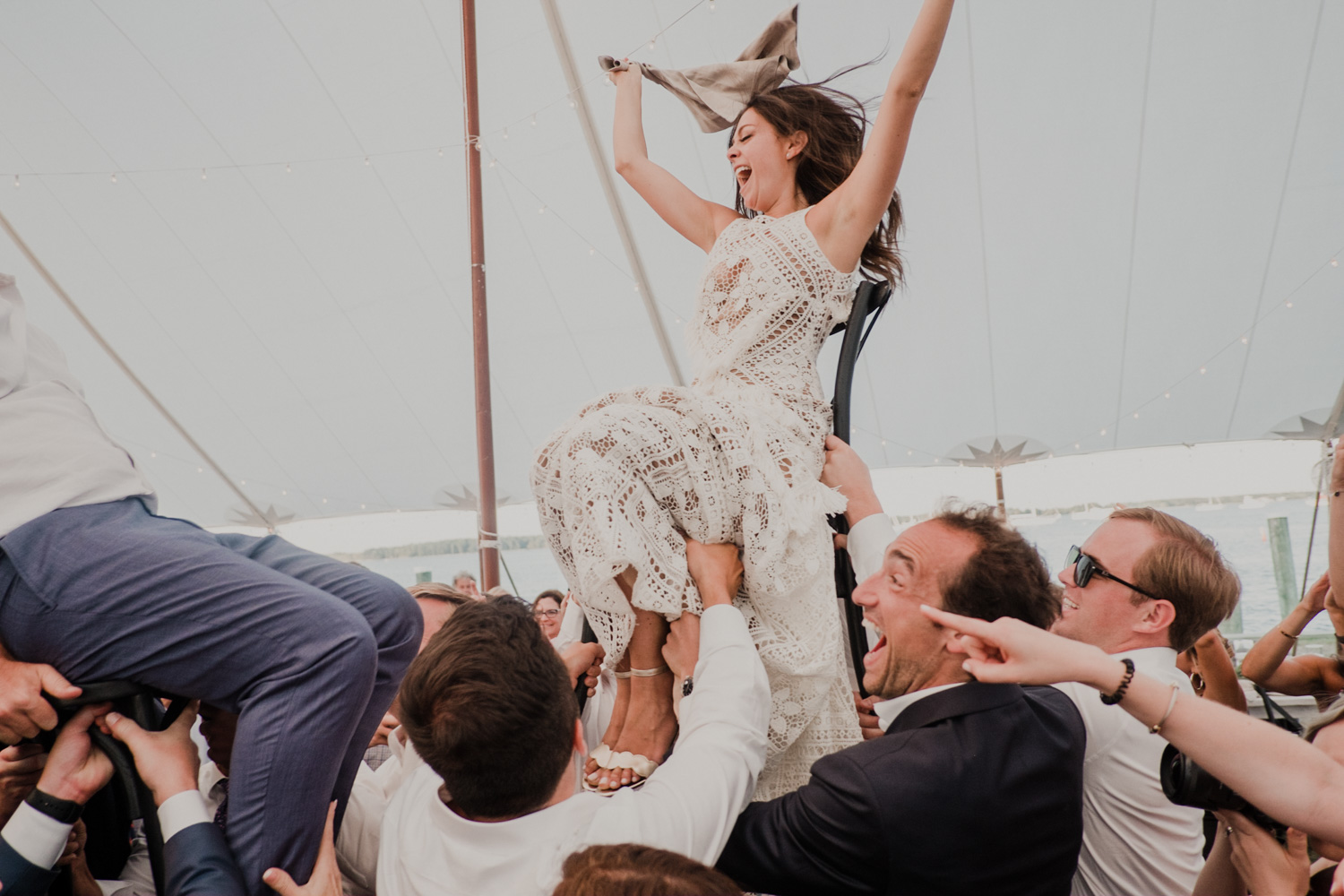 bride is raised in the air during the hora