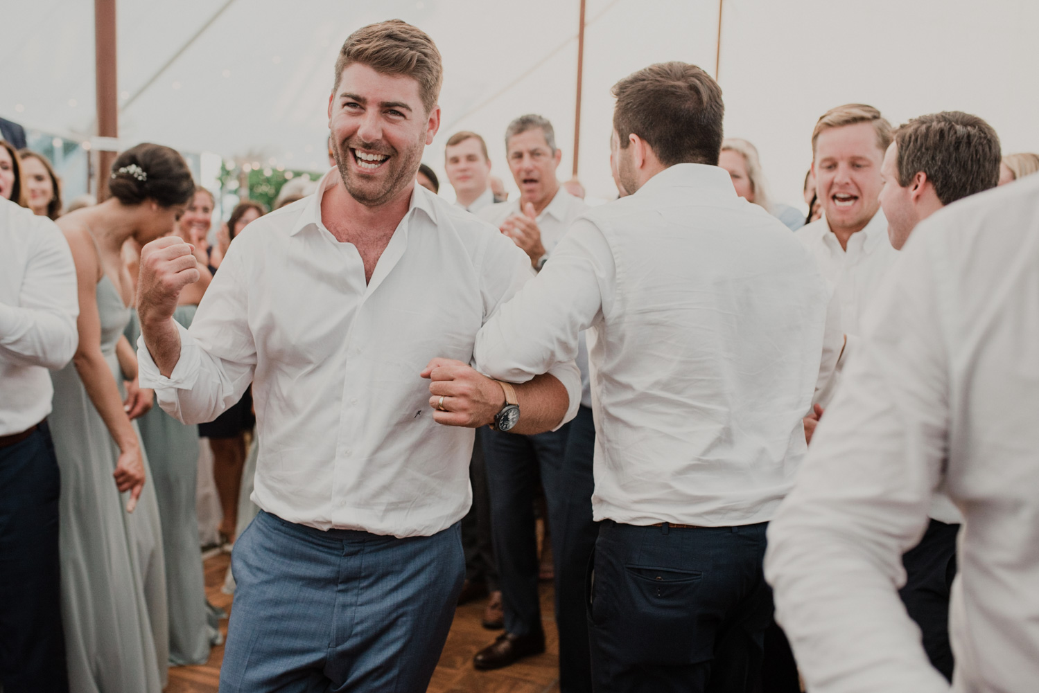 groom dances with guests during the hora
