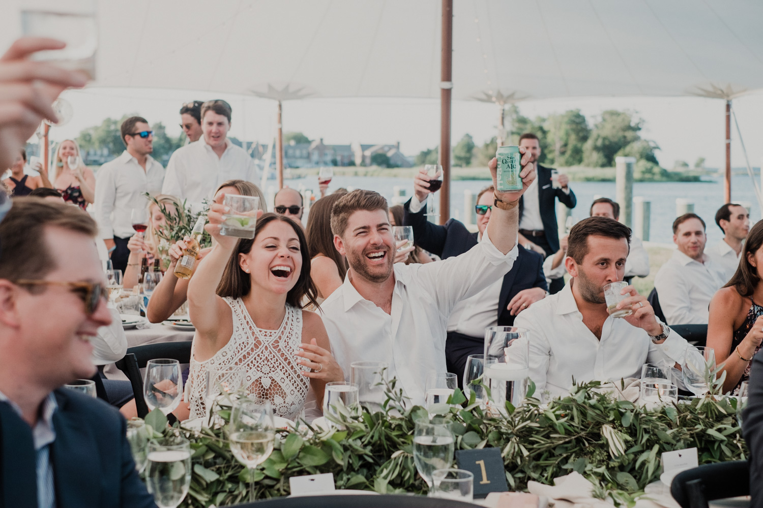 bride and groom raise their glasses during best man toast