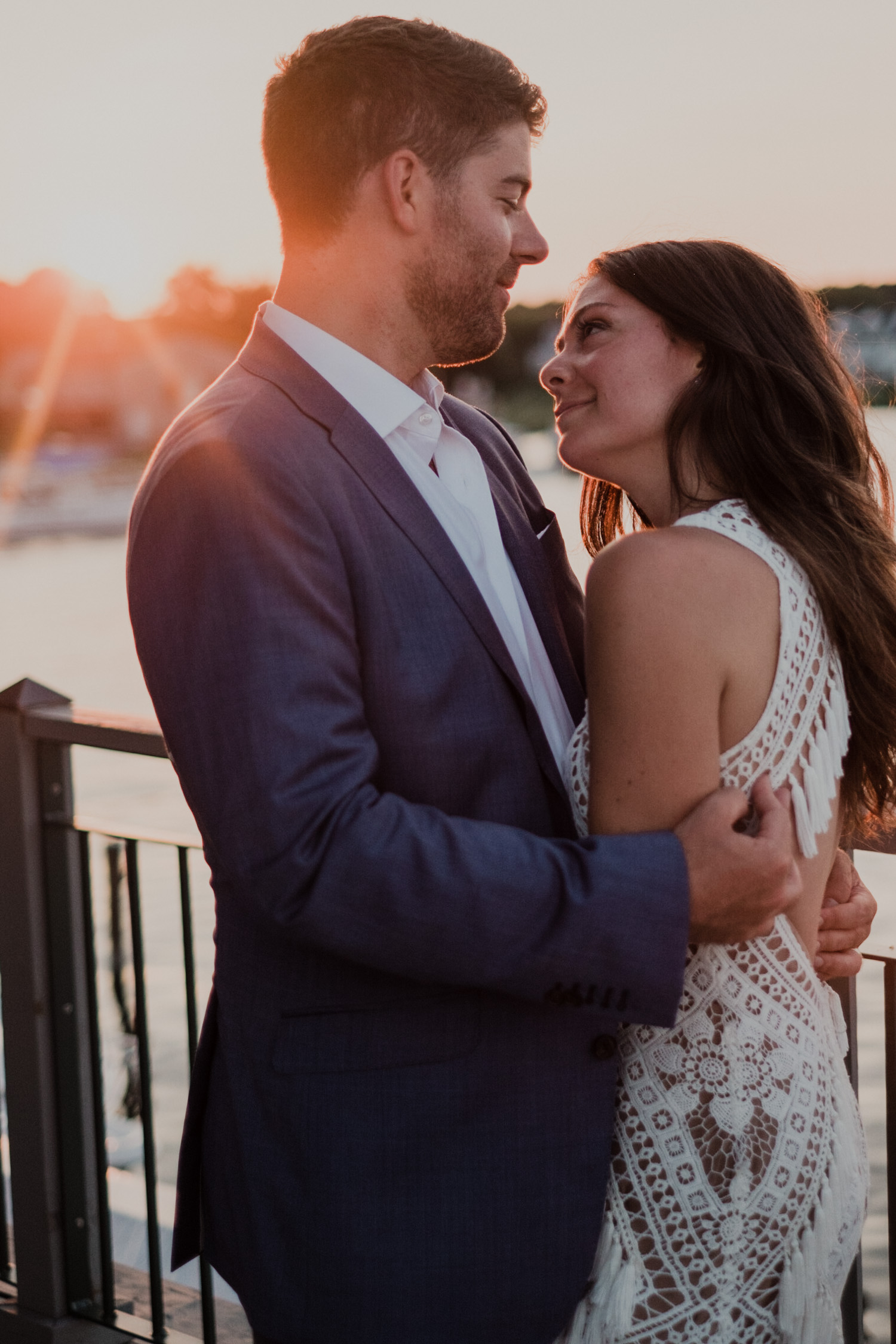 bride and groom looking at each other during sunset portraits