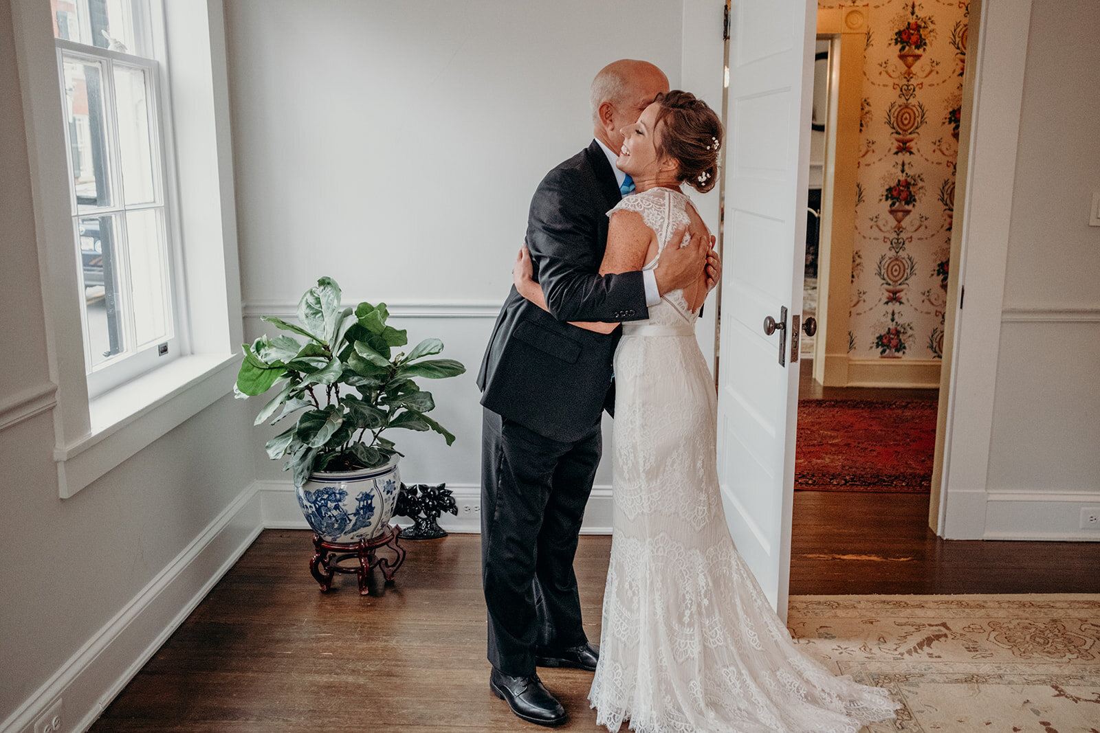 A bride hugs her dad after their first look at Birkby House in Leesburg, VA. 