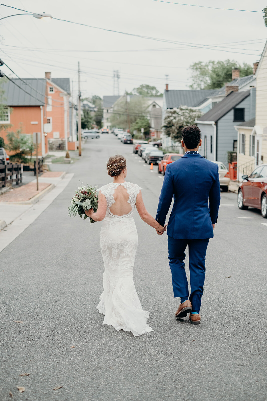 A bride and groom stroll down a street in Leesburg, VA.