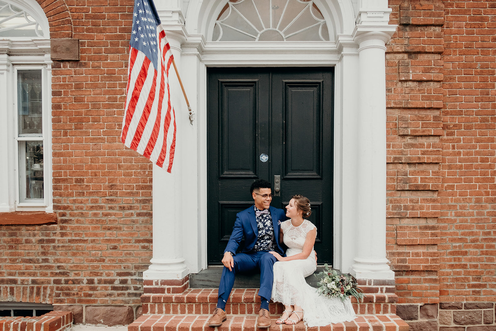 A bride and groom hang out on brick steps in downtown Leesburg, VA. 