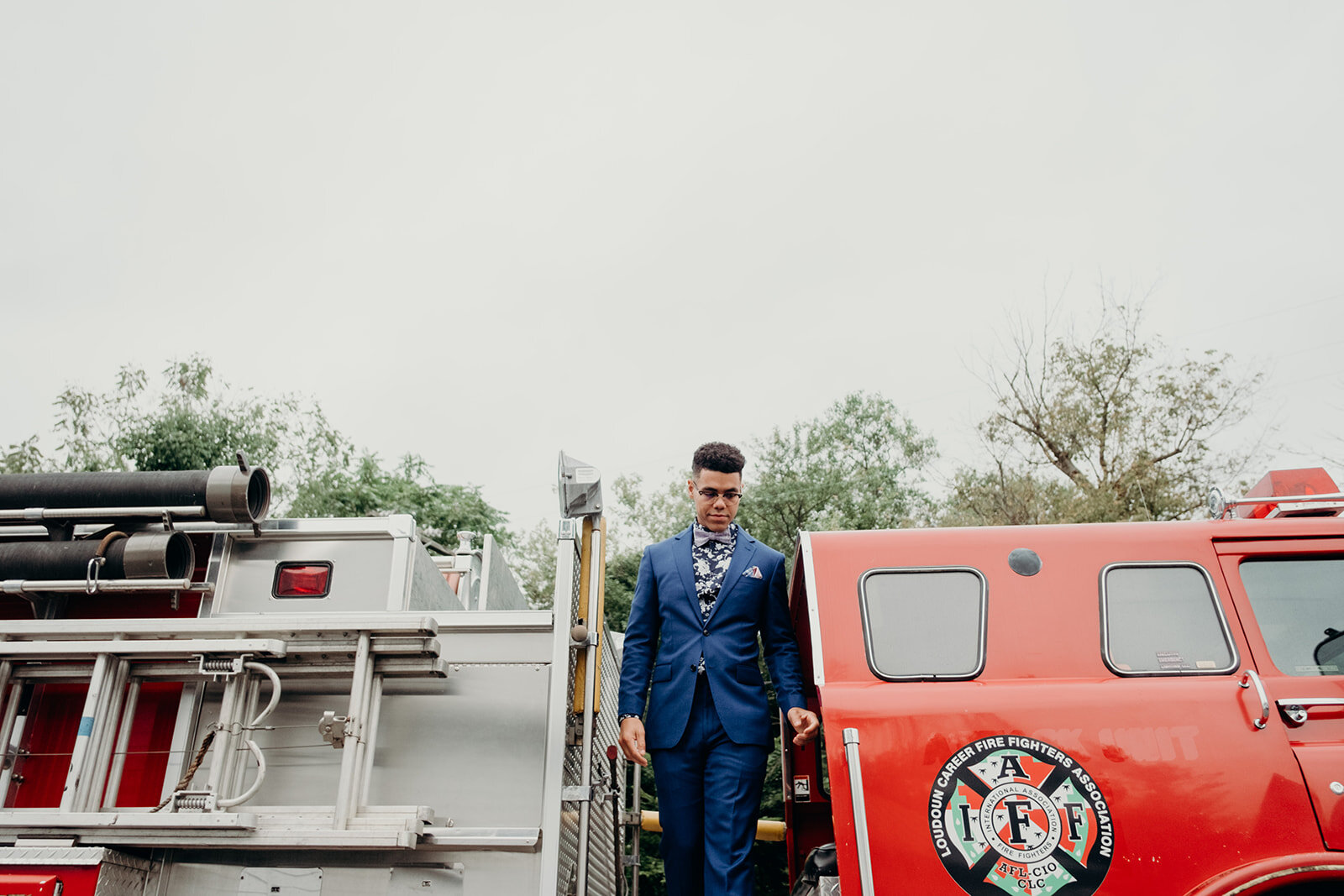 A groom steps off a firetruck to walk down the aisle at his wedding at Birkby House in Leesburg, VA.