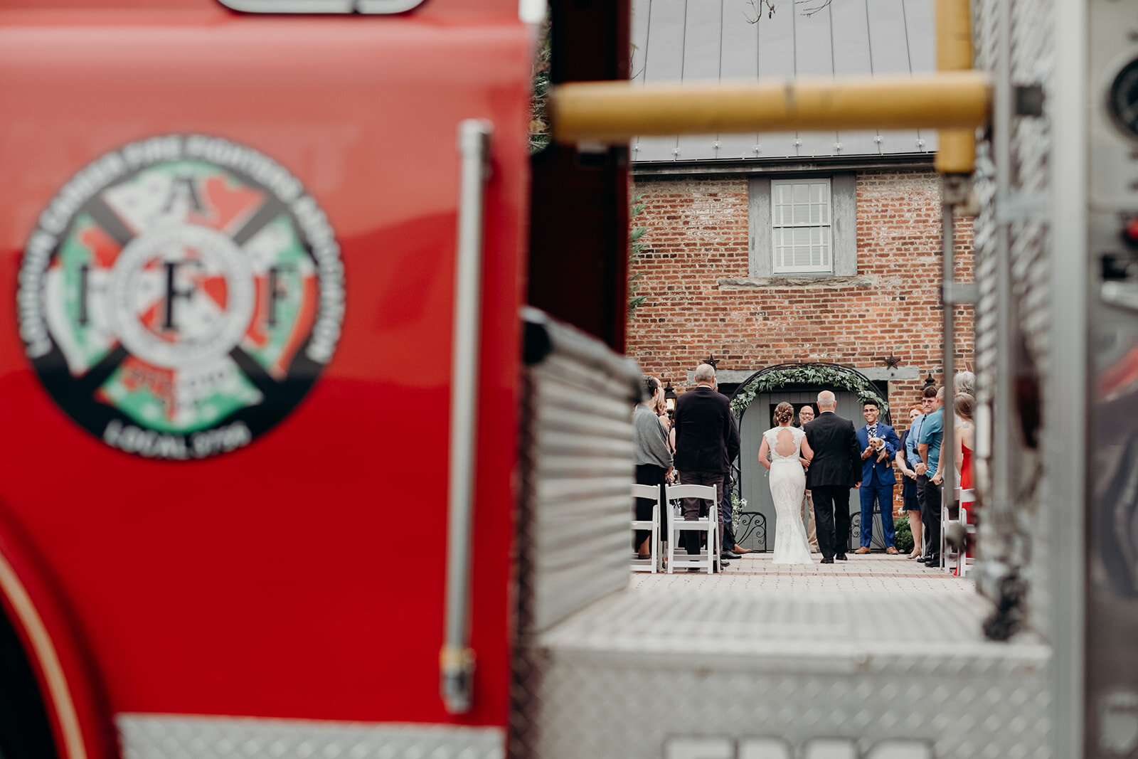A firetruck is parked outside an outdoor wedding ceremony at Birkby House in Leesburg, VA. 