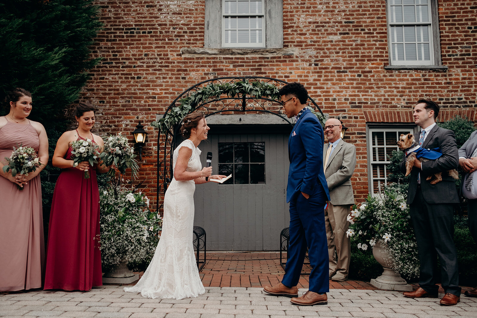 A bride reads her vows during an outdoor wedding ceremony at Birkby House in Leesburg, VA.