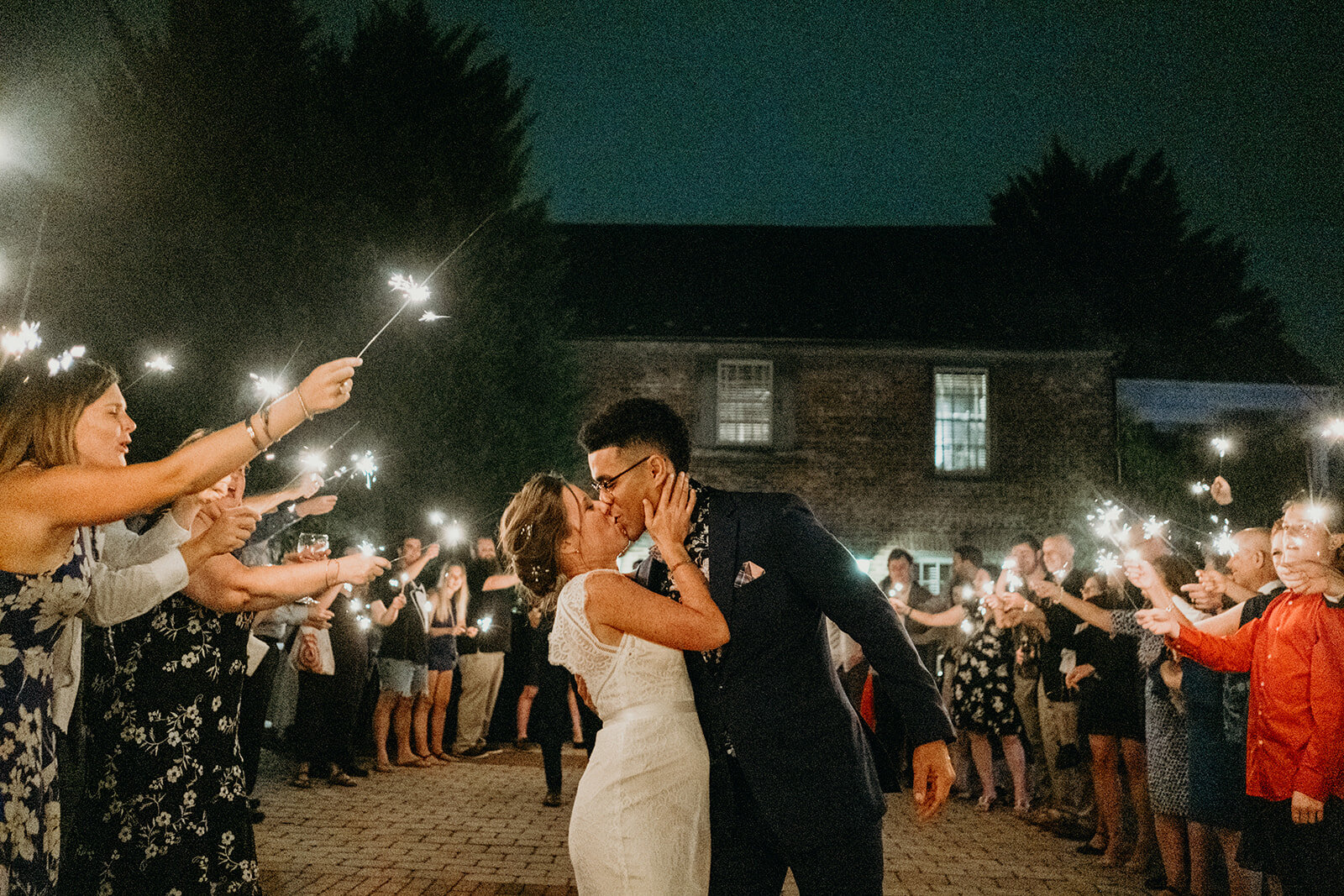 A bride and groom kiss during their sparkler exit at Birkby House in Leesburg, VA.
