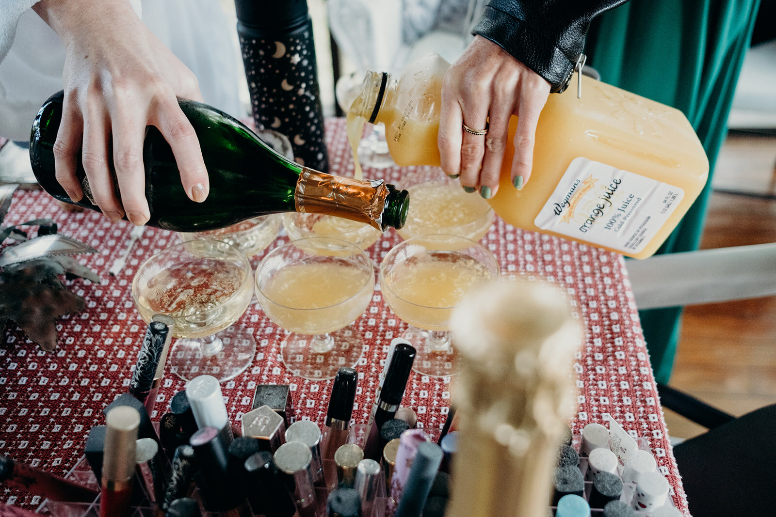Mimosas are made while guests get ready for an outdoor farm wedding.