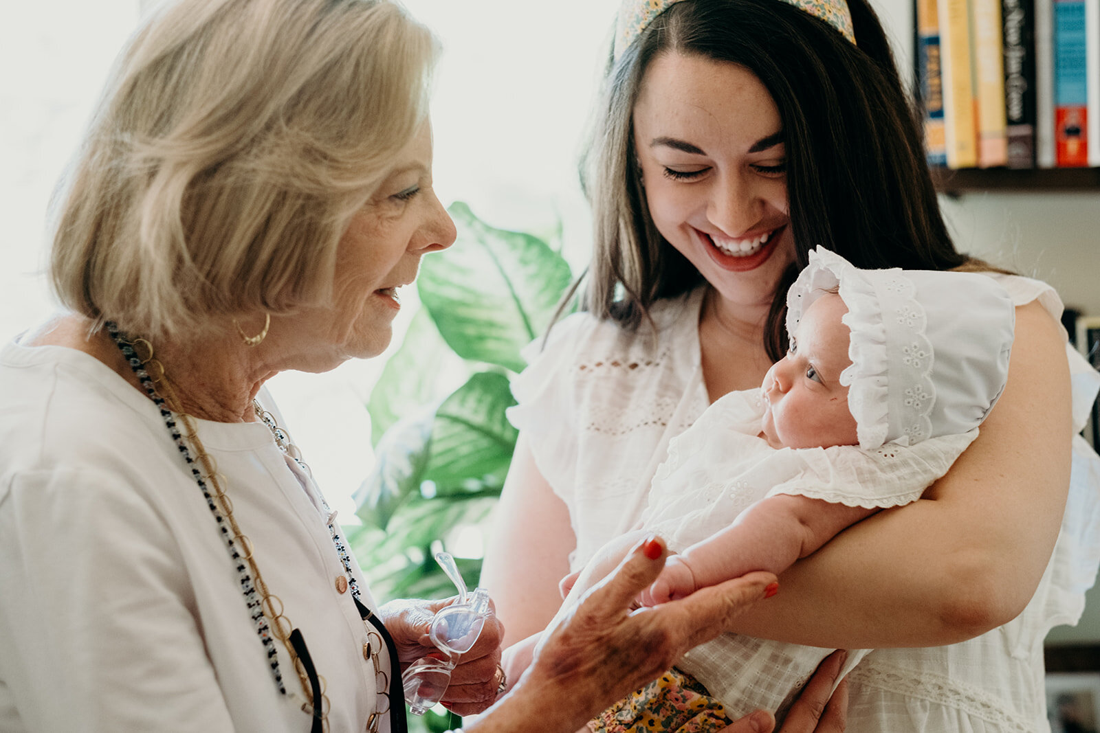 A grandmother greets her granddaughter and great granddaughter before her Jewish naming ceremony.