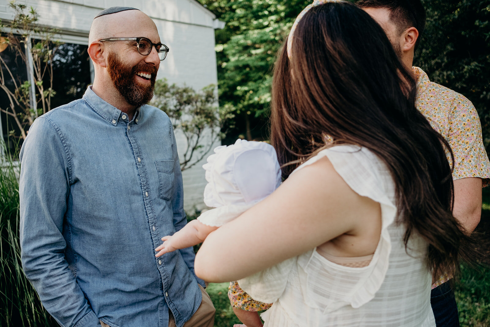A rabbi talks to the parents before a Jewish baby naming ceremony. 