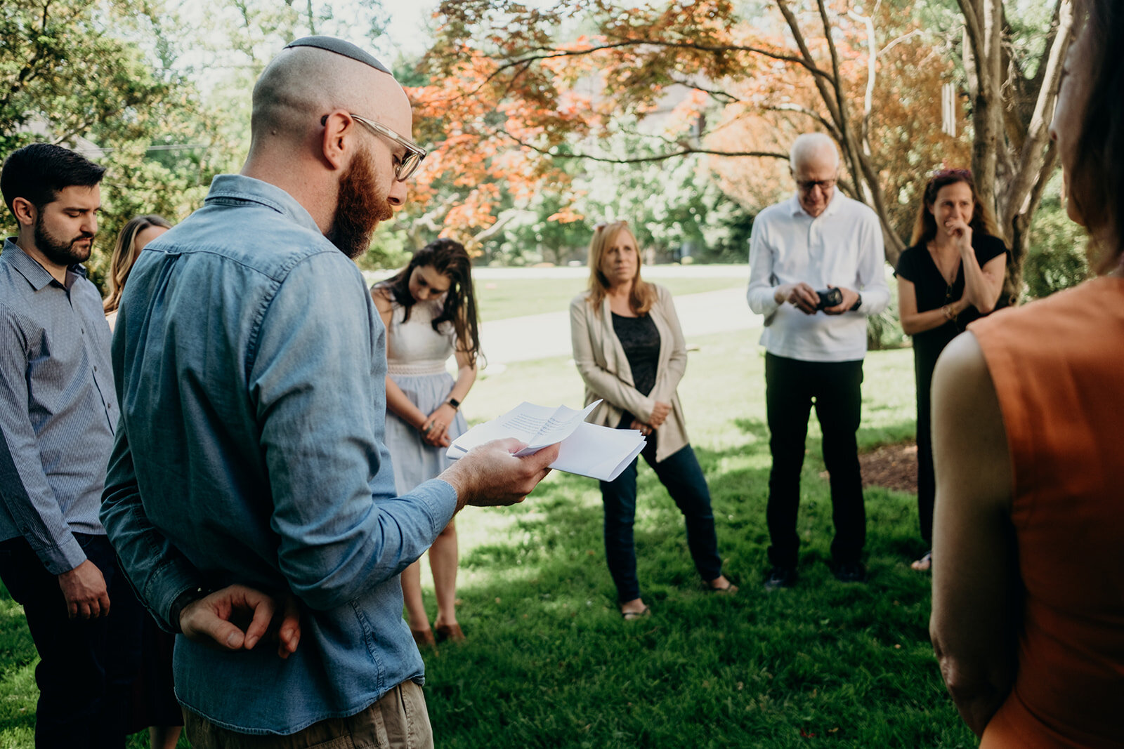 A rabbi prays at a Jewish baby naming ceremony.