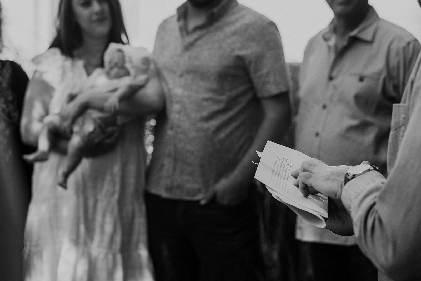 A rabbi continues prayers for the Jewish baby naming ceremony.