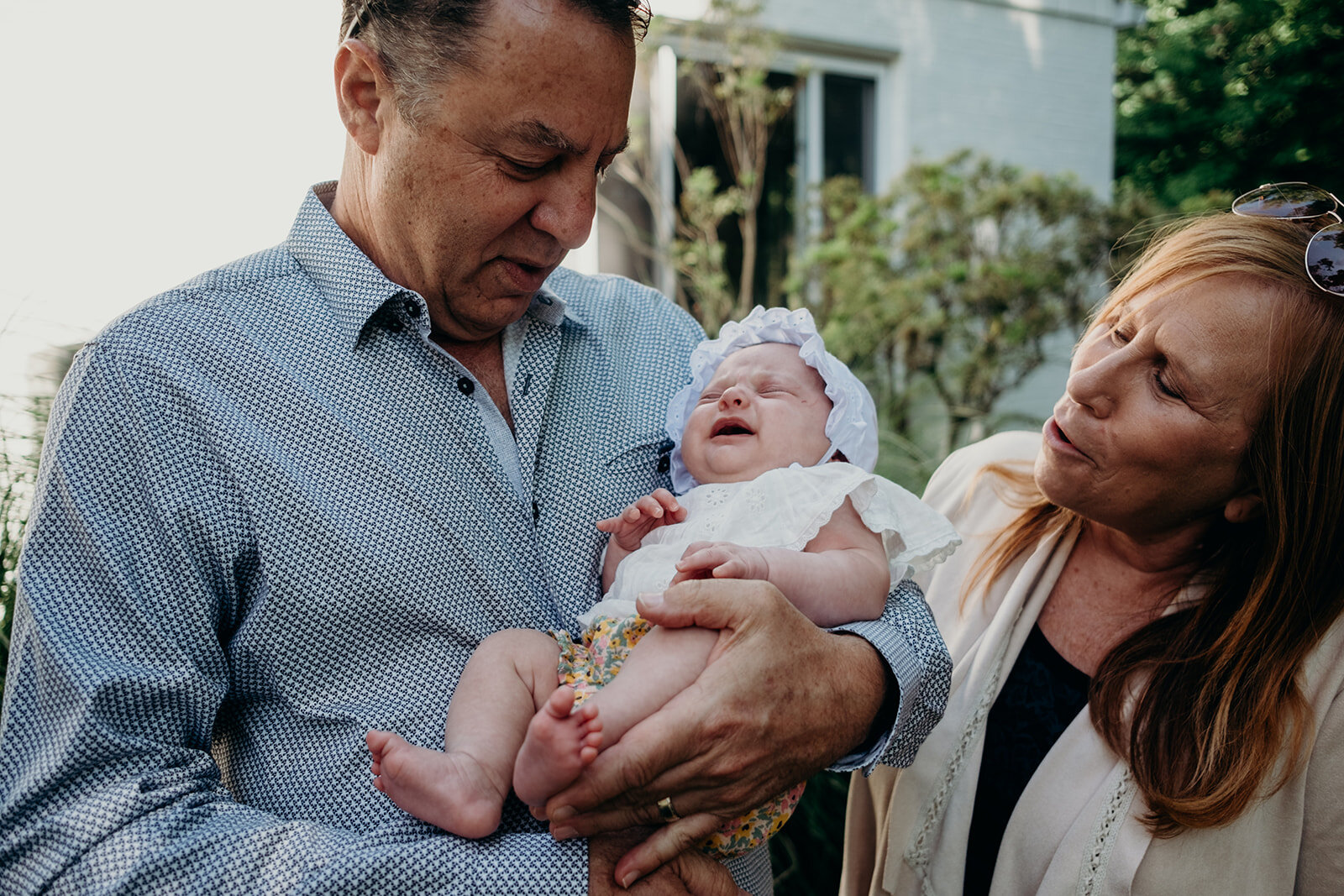 Grandparents try to calm their granddaughter during a Jewish baby naming ceremony.