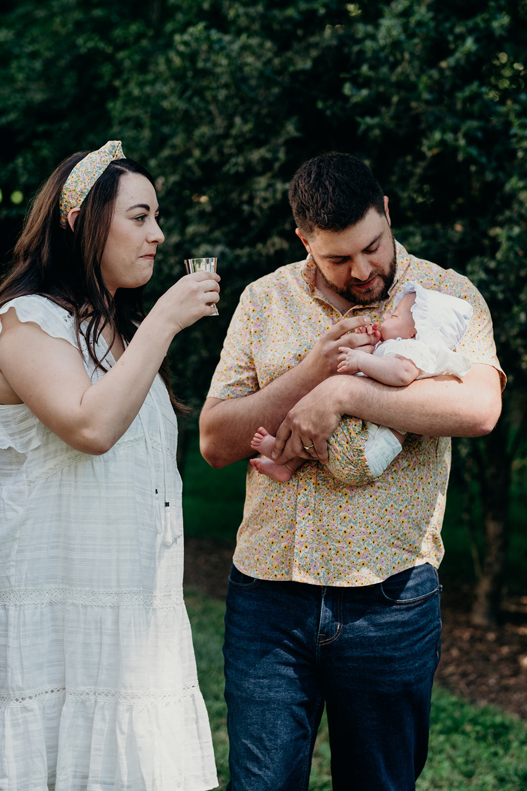 A mother takes part in the wine during the Jewish baby naming ceremony.