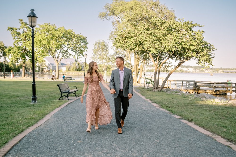 Engagement session couple walking down path with Potomac River in the background
