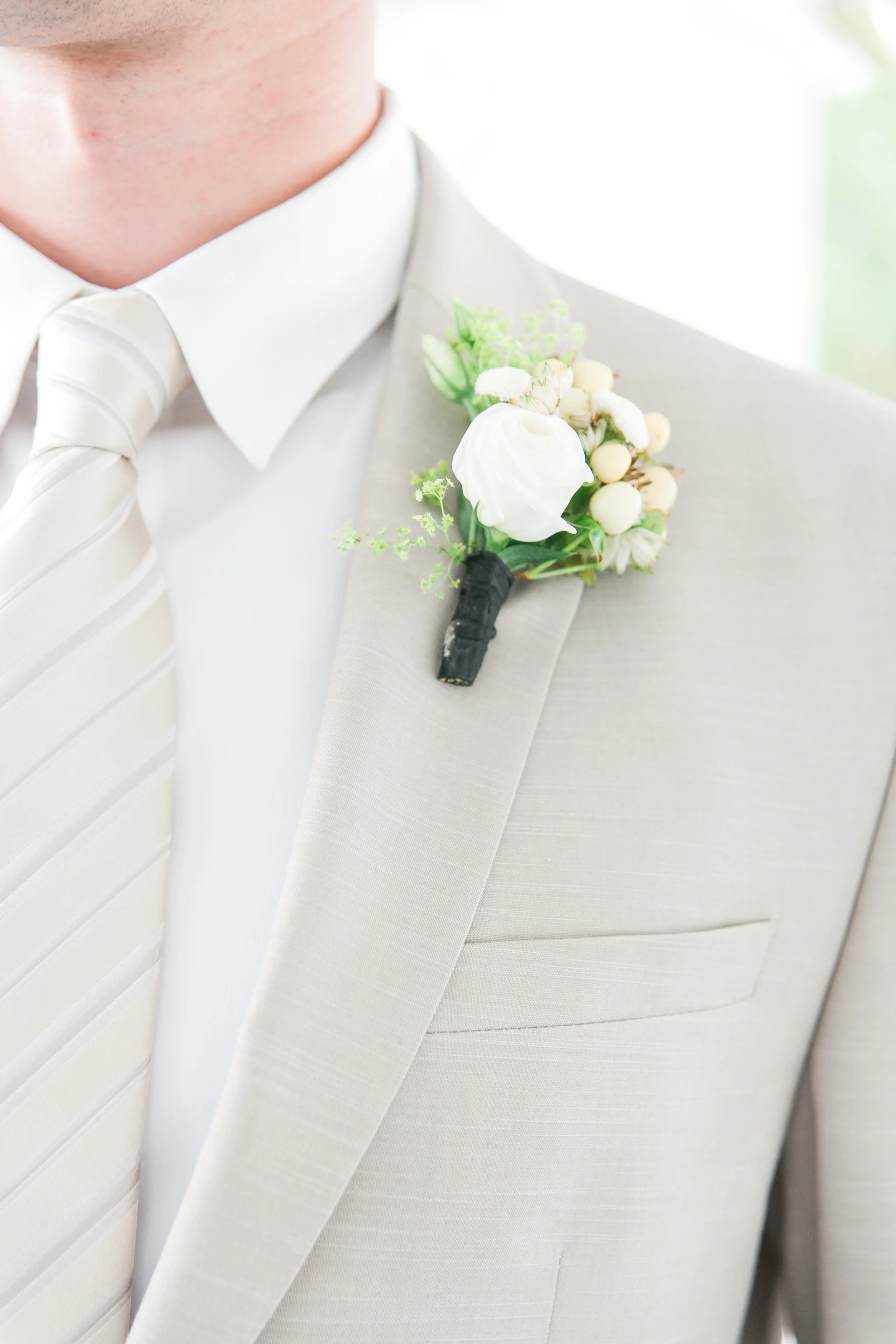 Groom's neutral boutonniere detail