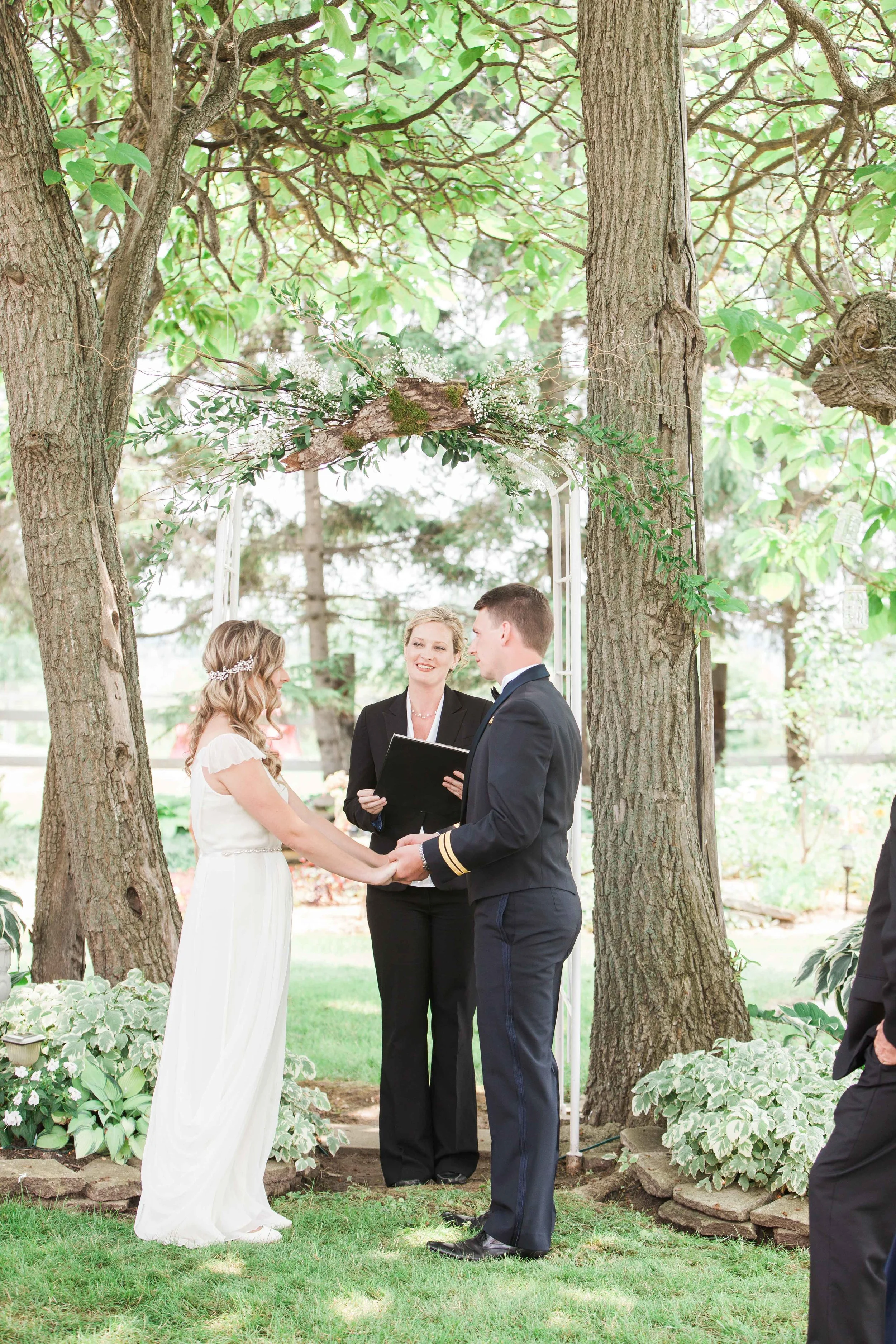 Bride and groom exchanging vows at outdoor wedding