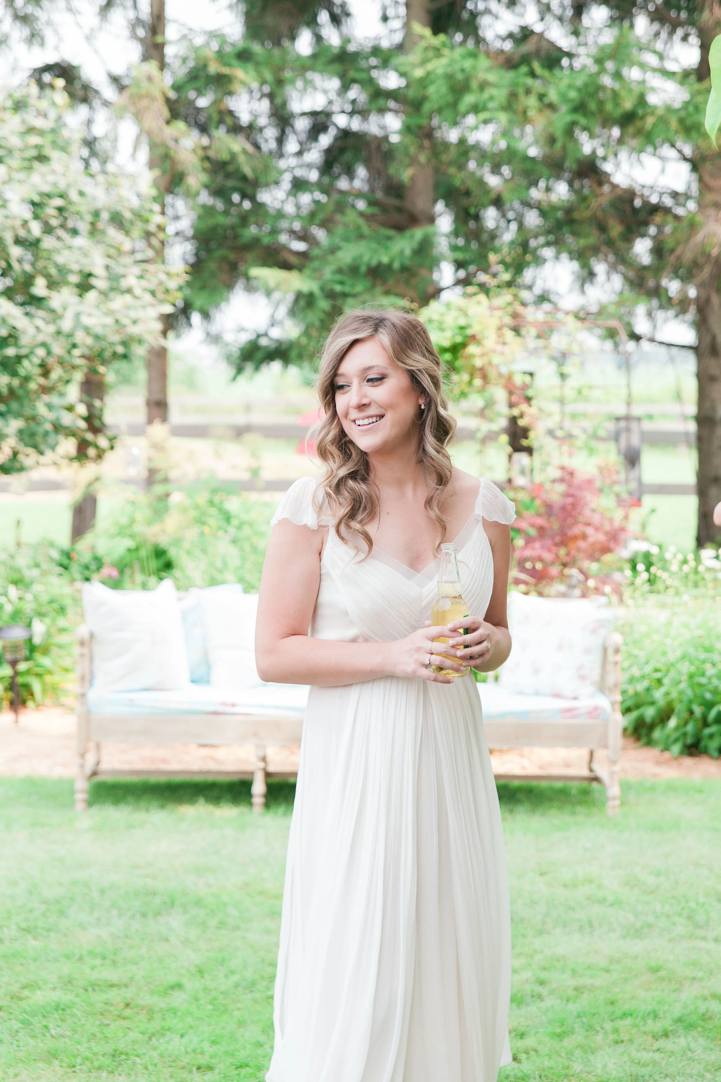 Bride at cocktail hour at farm wedding