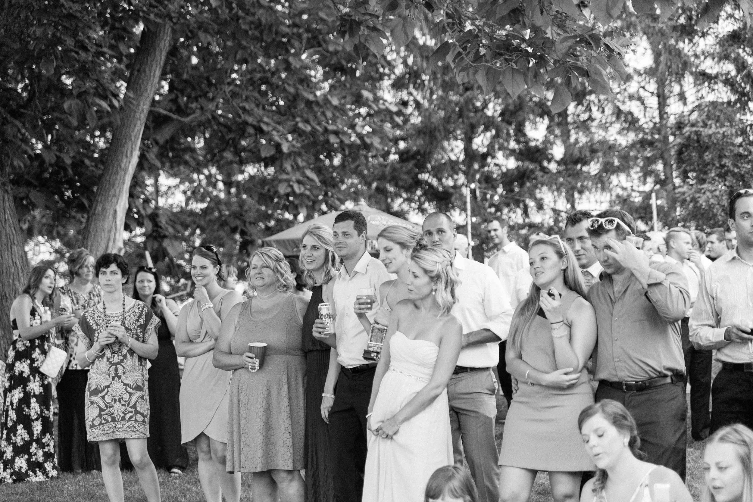 Guests watching first dance at farm wedding
