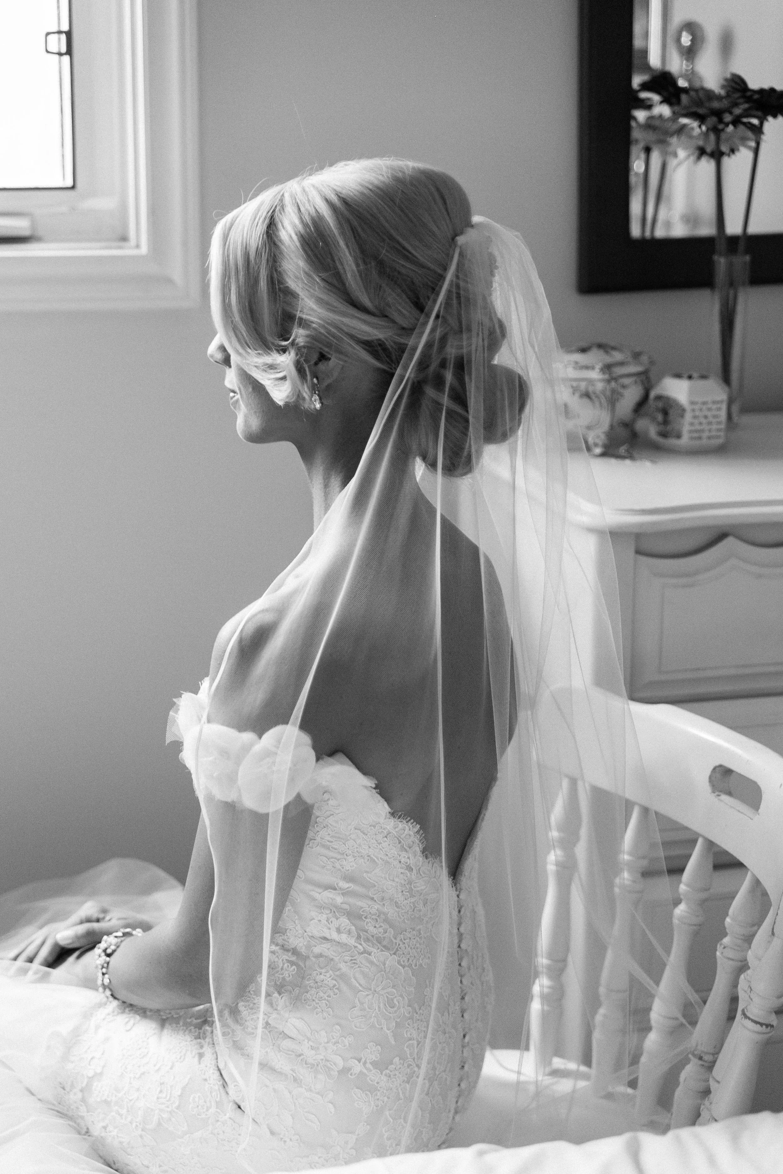 Black and white portrait of bride in her wedding dress