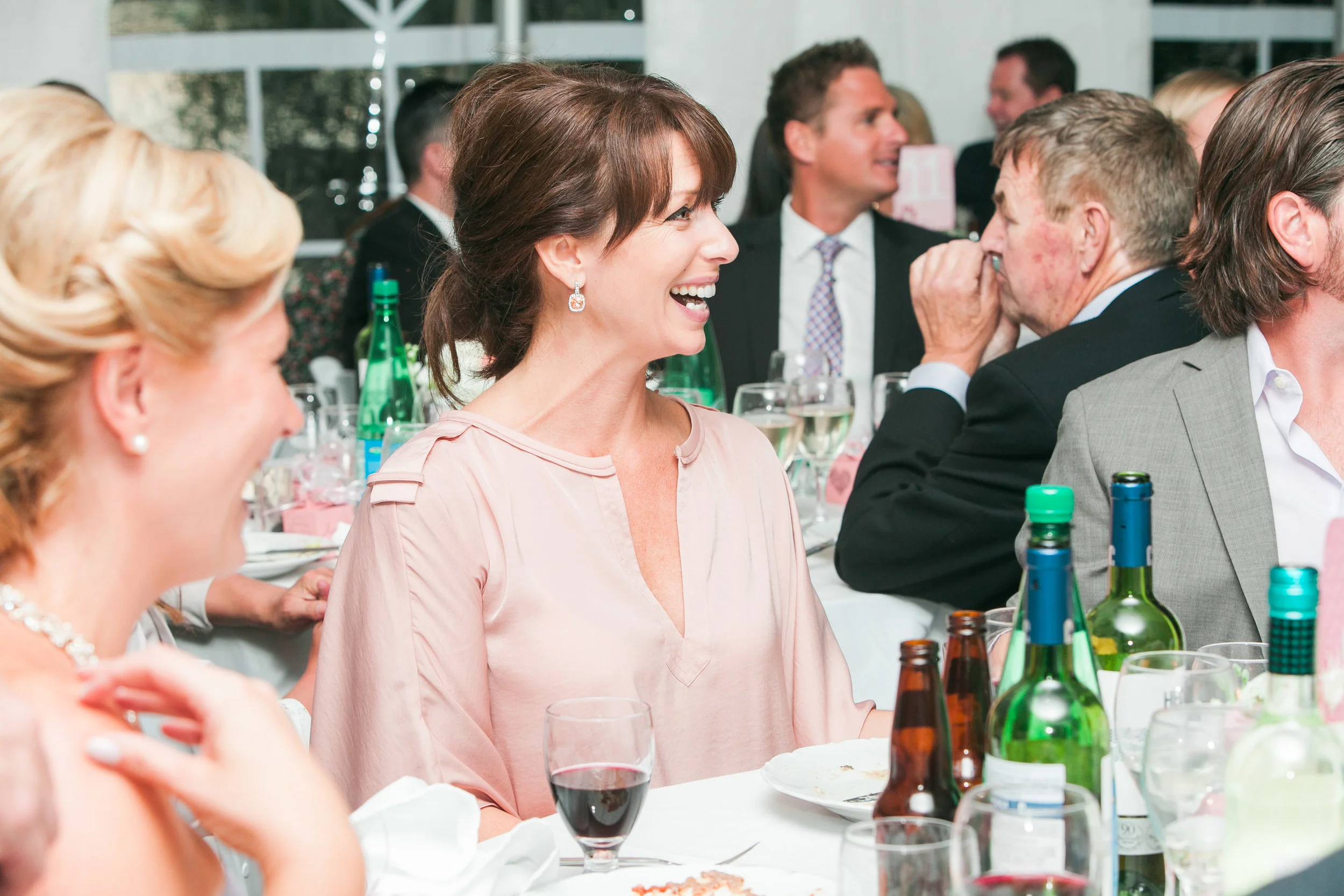 Guest laughing at speeches during dinner