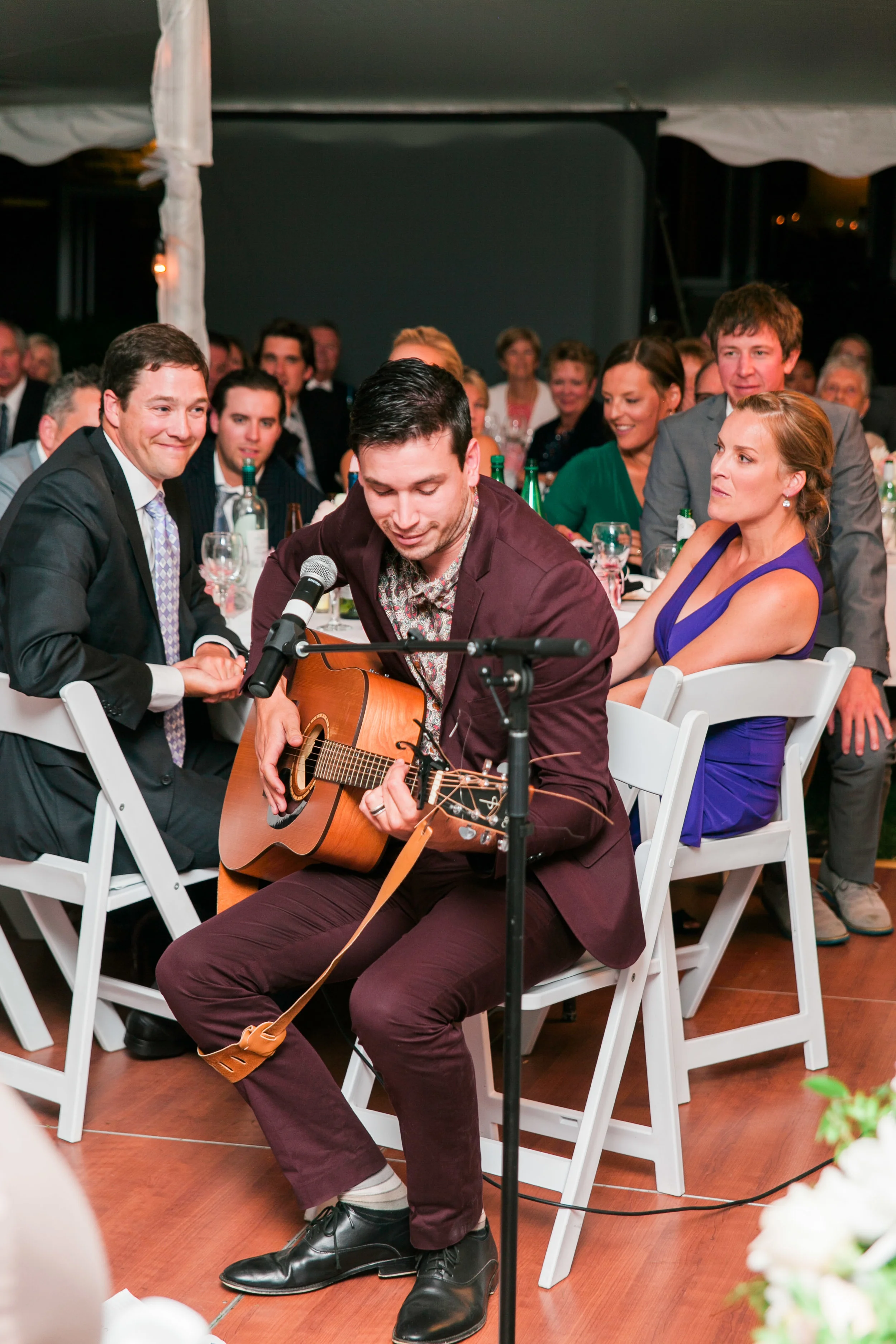 Man playing couple's first dance song on guitar