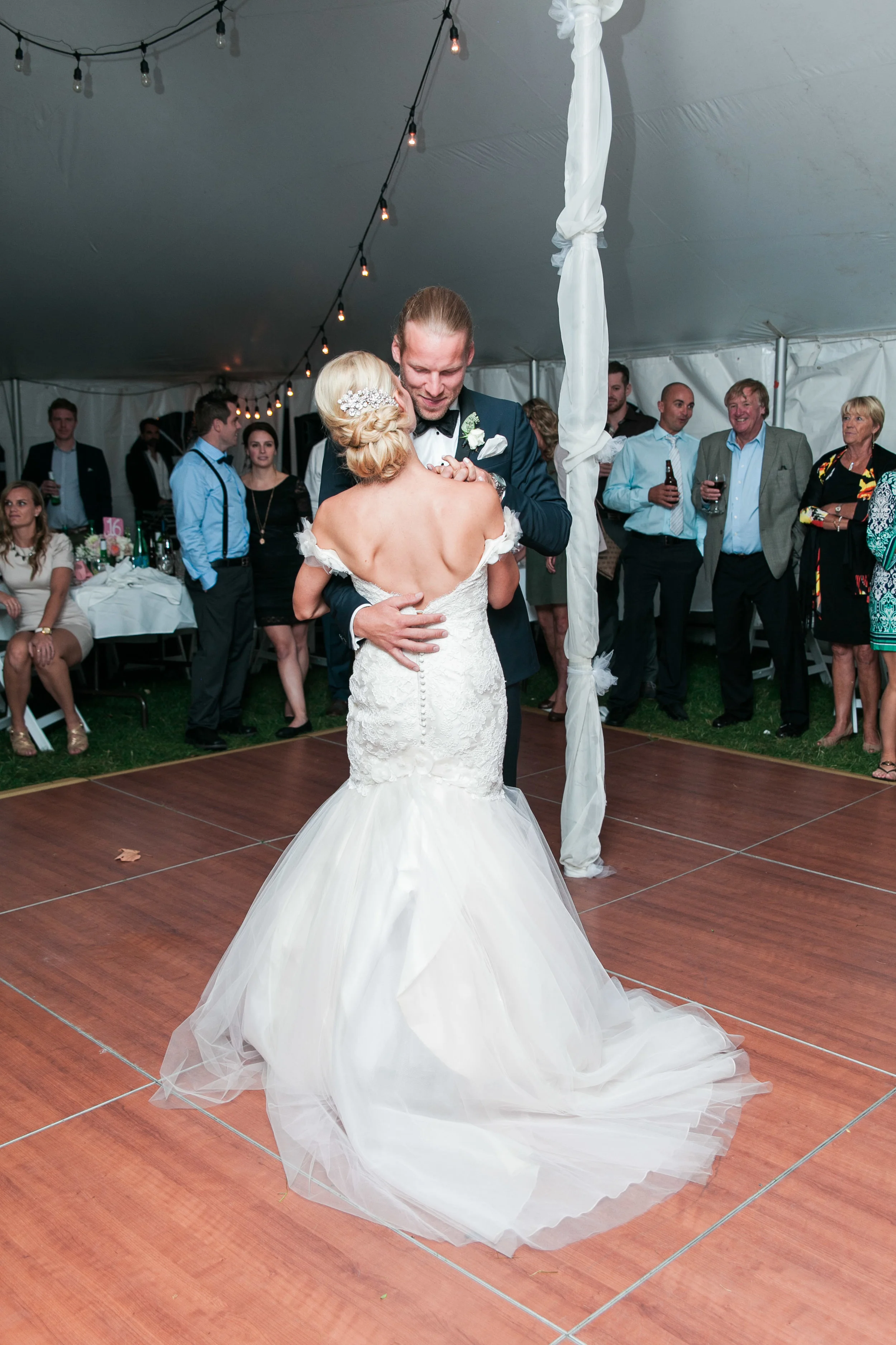 Couple during first dance at tented wedding
